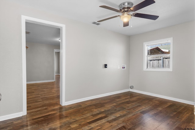 clothes washing area featuring dark wood-type flooring, hookup for a washing machine, visible vents, and baseboards