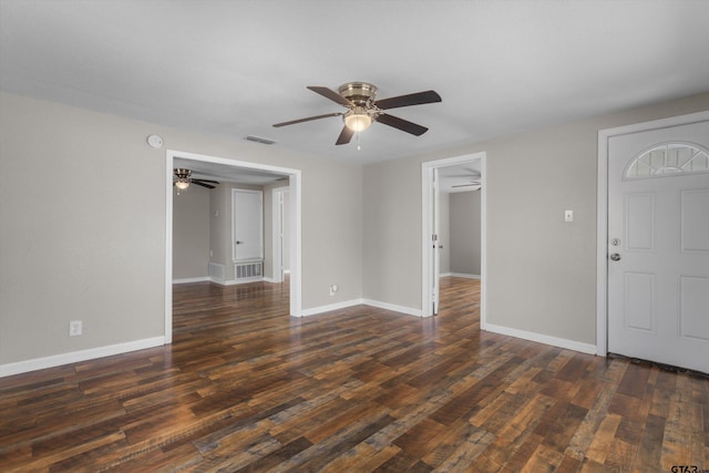 interior space featuring visible vents, baseboards, and dark wood finished floors