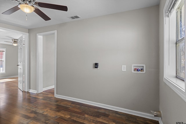 spare room featuring dark wood-style floors, baseboards, and visible vents