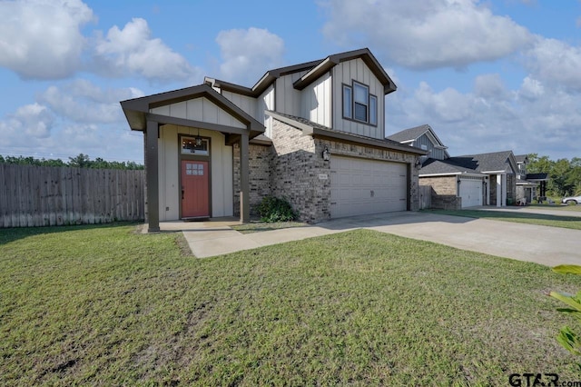 view of front of property with a front yard and a garage