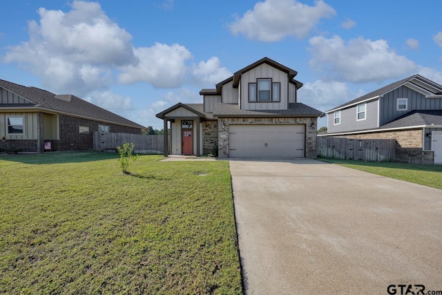 view of front of home with a front yard and a garage