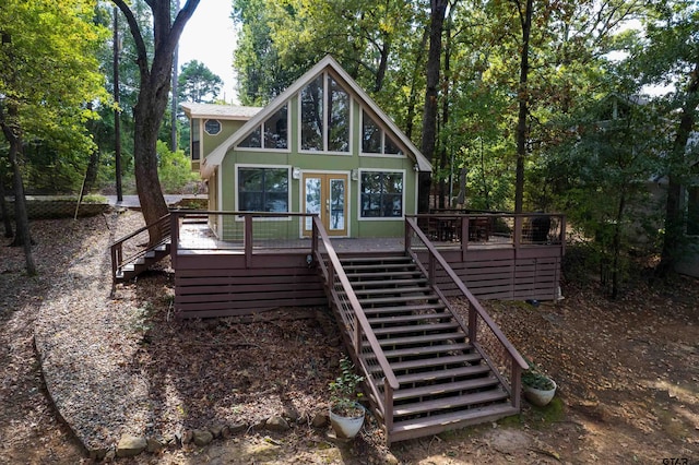 back of house with a deck