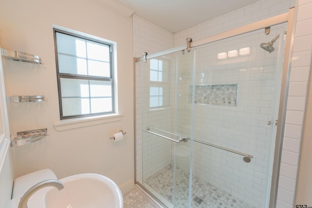 bathroom with sink, tile patterned floors, and a shower with door