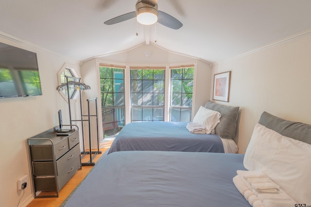 bedroom featuring light wood-type flooring, ceiling fan, crown molding, and vaulted ceiling