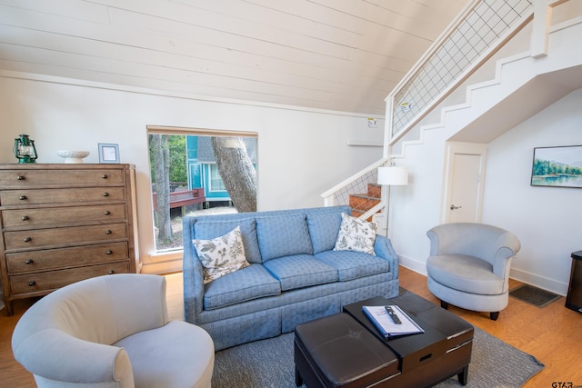 living room featuring hardwood / wood-style floors, wood ceiling, and crown molding