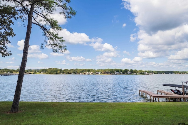 dock area featuring a water view and a yard