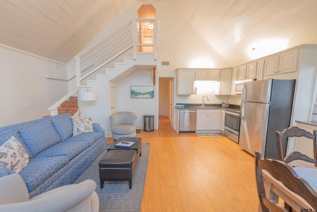 living room featuring high vaulted ceiling, light wood-type flooring, wood ceiling, and sink