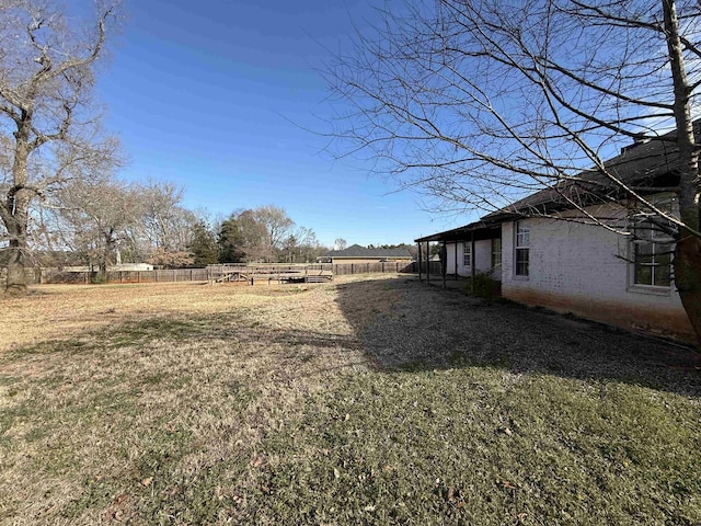 view of yard with a rural view and fence