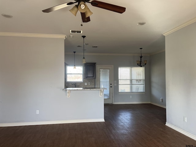 unfurnished living room featuring dark wood-type flooring, ceiling fan, and crown molding