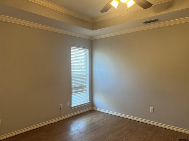 empty room with ceiling fan, dark hardwood / wood-style flooring, and crown molding