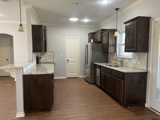 kitchen featuring a kitchen breakfast bar, decorative light fixtures, dishwasher, and sink