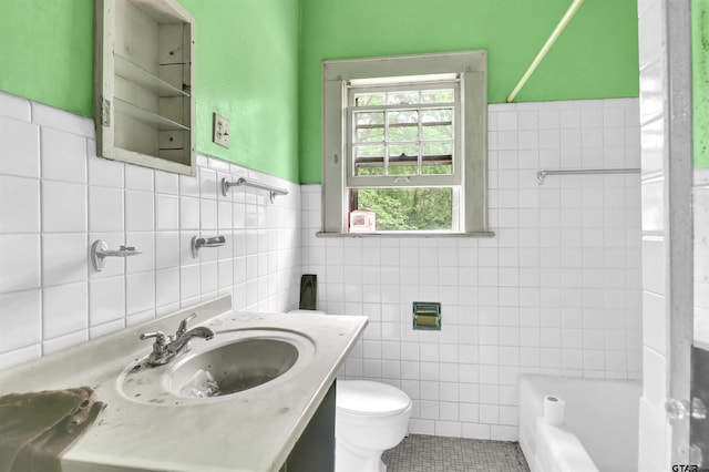 bathroom with a wainscoted wall, tile patterned floors, toilet, tile walls, and shower / tub combination