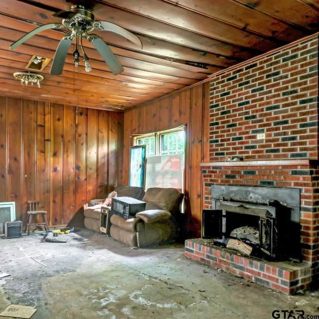 living area with wooden walls, a ceiling fan, and wooden ceiling