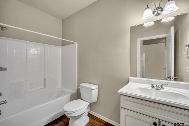 full bathroom featuring bathing tub / shower combination, vanity, hardwood / wood-style flooring, and toilet