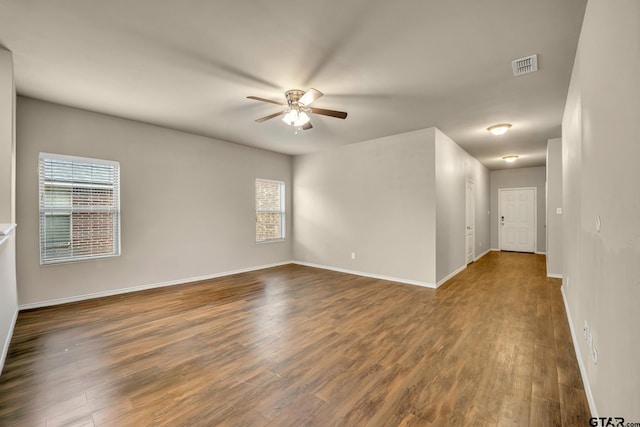 spare room with dark hardwood / wood-style floors and ceiling fan