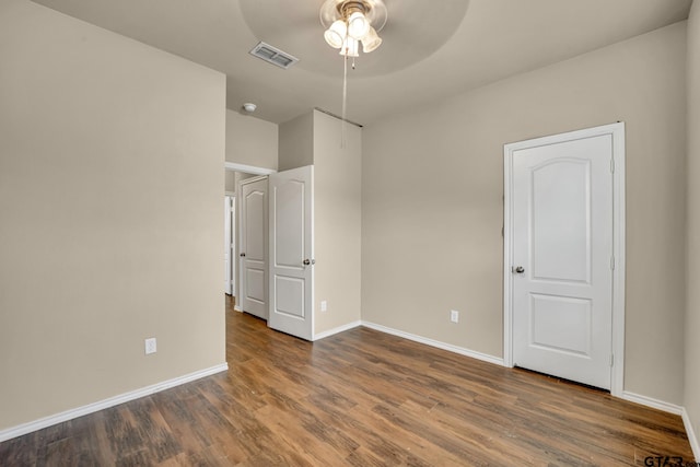 unfurnished bedroom featuring dark wood-type flooring and ceiling fan