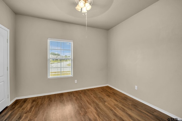 empty room with dark hardwood / wood-style flooring and ceiling fan