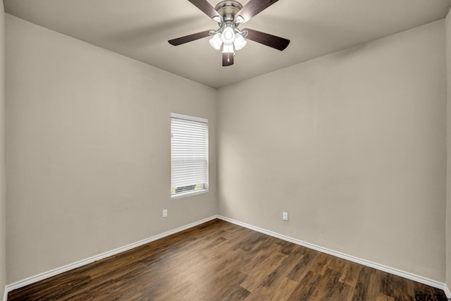 spare room with dark wood-type flooring and ceiling fan