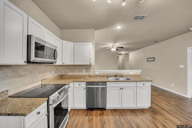 kitchen featuring stainless steel appliances, light hardwood / wood-style floors, white cabinetry, and sink