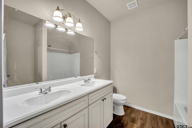 full bathroom featuring shower / bathing tub combination, vanity, hardwood / wood-style flooring, and toilet