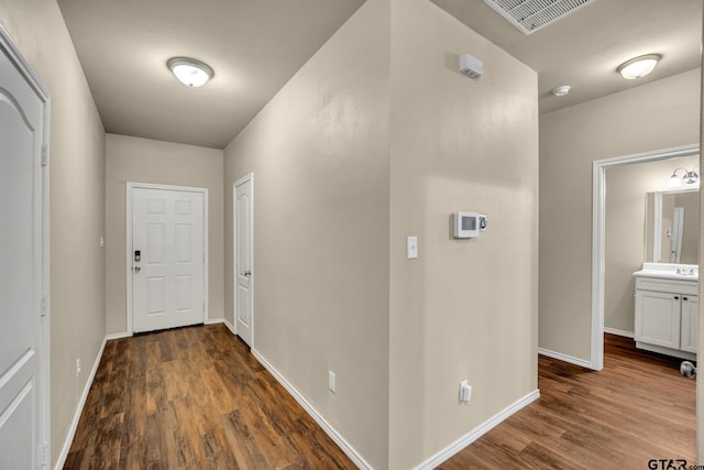 corridor featuring dark hardwood / wood-style floors