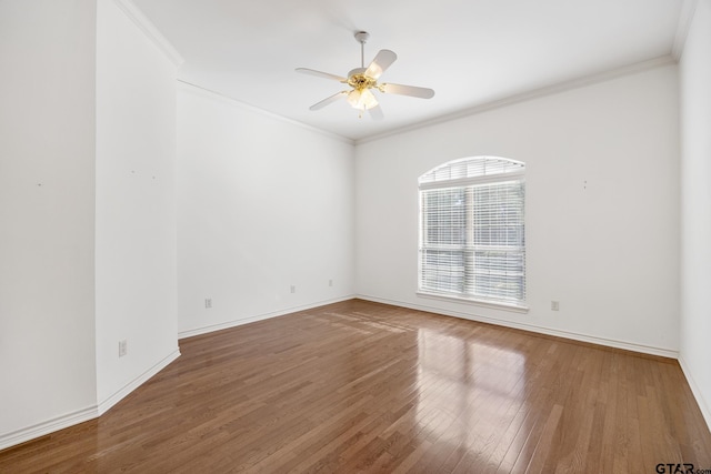 empty room featuring wood-type flooring, ceiling fan, and crown molding