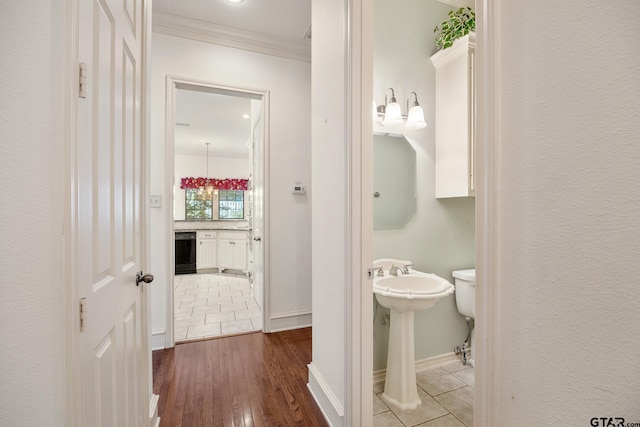 bathroom with hardwood / wood-style floors and ornamental molding