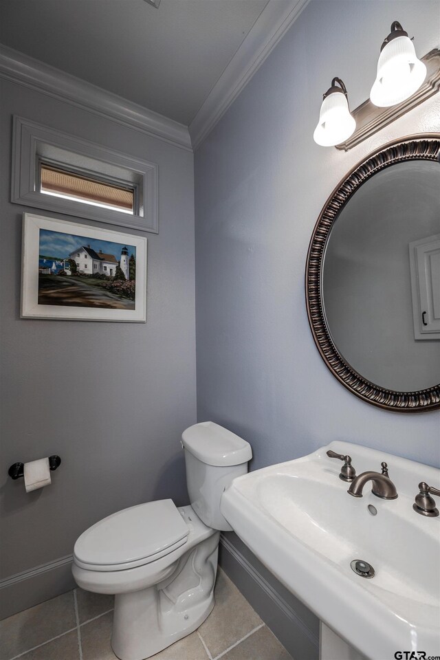 bathroom with sink, crown molding, toilet, and tile patterned floors