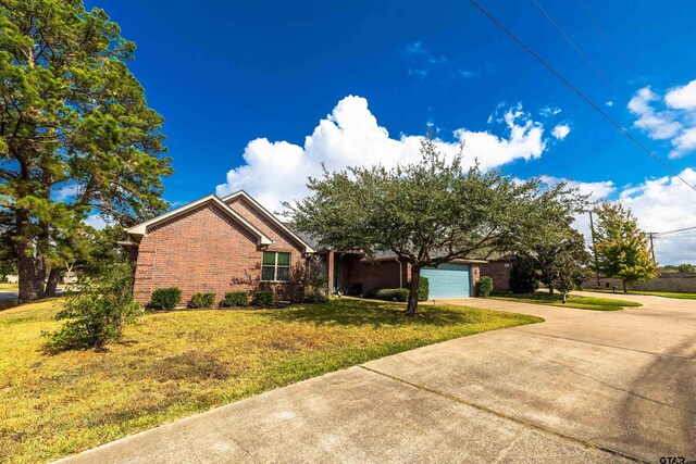 view of front of house with a garage and a front yard