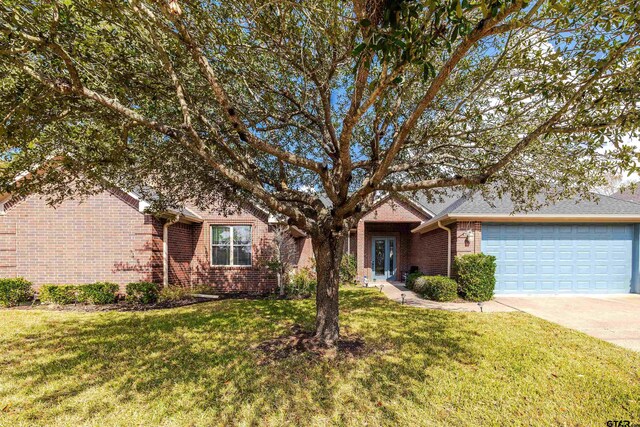 ranch-style house with a front yard and a garage