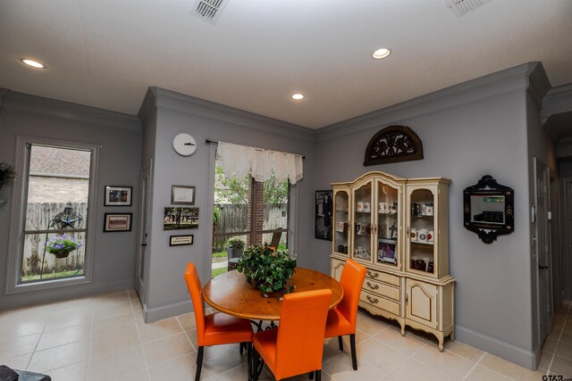 tiled dining area featuring ornamental molding