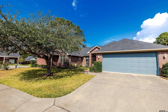 view of front of home with a front yard and a garage