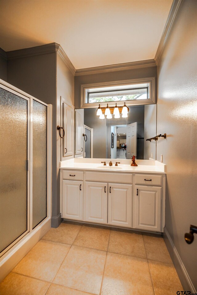 bathroom with ornamental molding, vanity, a shower with door, and tile patterned floors