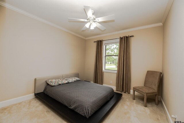 carpeted bedroom featuring crown molding and ceiling fan