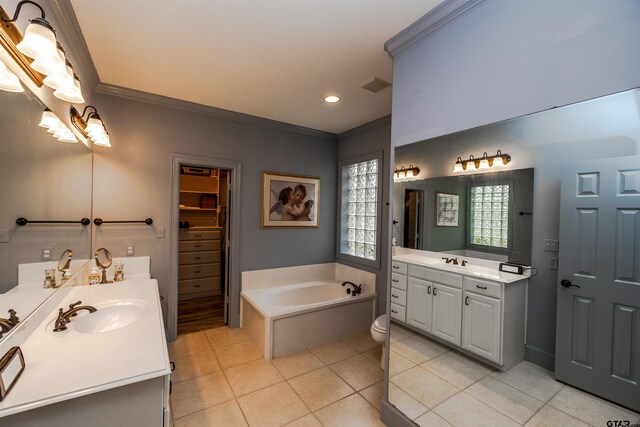 bathroom featuring tile patterned floors, ornamental molding, vanity, and a bath