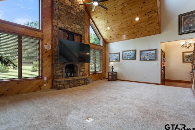 5766 Fm 279, Ben Wheeler, TX 75754 - unfurnished living room featuring a fireplace, high vaulted ceiling, carpet, a ceiling fan, and wood walls