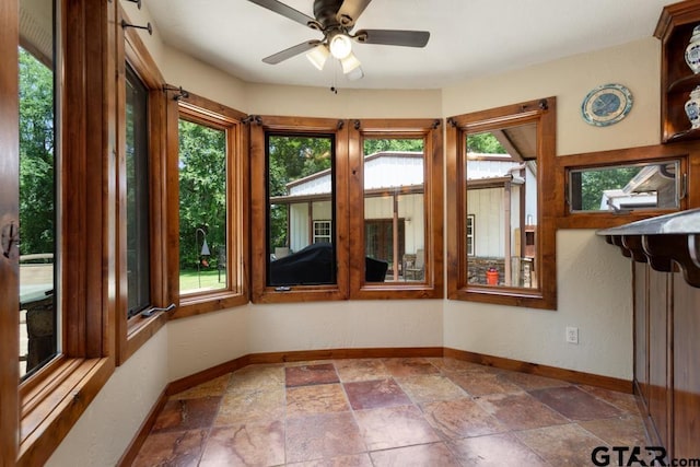 5766 Fm 279, Ben Wheeler, TX 75754 - unfurnished sunroom with baseboards and stone tile flooring