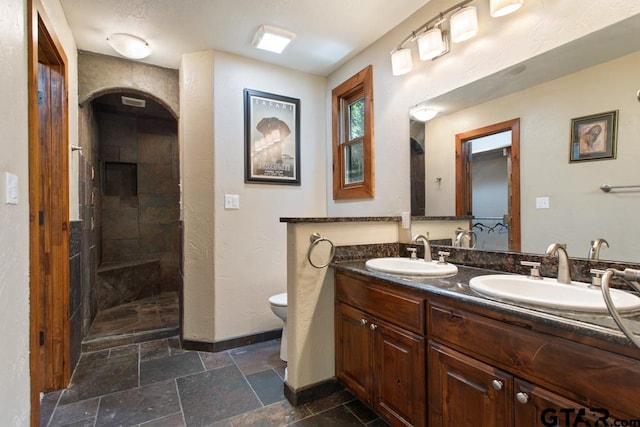 5766 Fm 279, Ben Wheeler, TX 75754 - bathroom featuring double vanity, stone tile flooring, and walk in shower