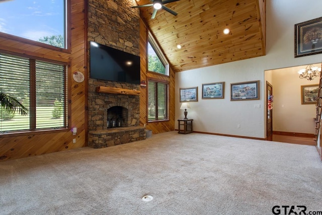 5766 Fm 279, Ben Wheeler, TX 75754 - unfurnished living room featuring high vaulted ceiling, a ceiling fan, carpet flooring, a stone fireplace, and wood walls