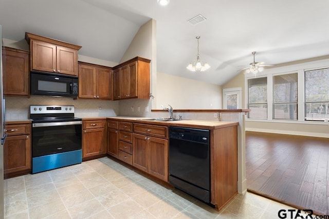 kitchen with kitchen peninsula, ceiling fan with notable chandelier, vaulted ceiling, sink, and black appliances