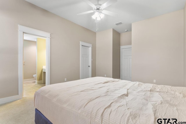 carpeted bedroom with connected bathroom and ceiling fan