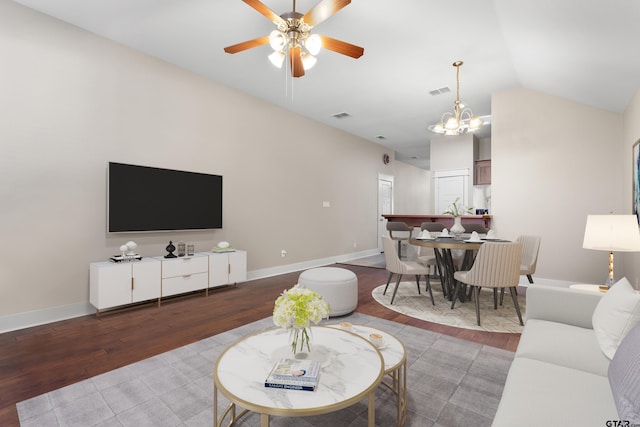 6023 Grace Ave, Tyler, TX 75707 - living room featuring wood finished floors, ceiling fan, a chandelier, vaulted ceiling, and baseboards