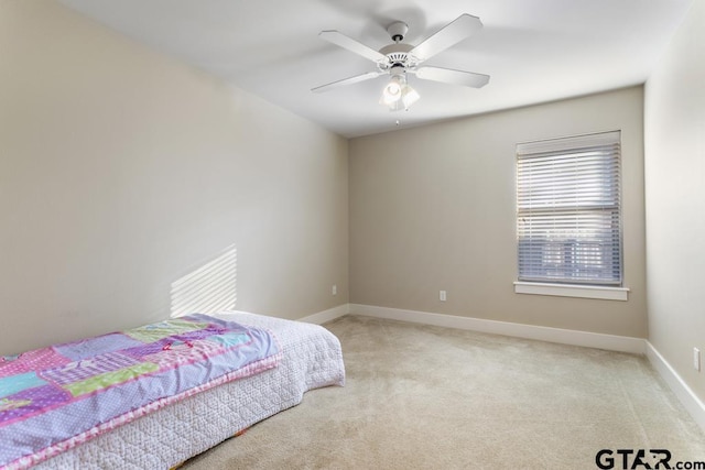 bedroom with ceiling fan and light carpet