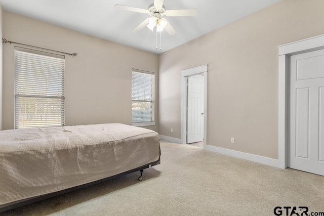 bedroom featuring light colored carpet and ceiling fan