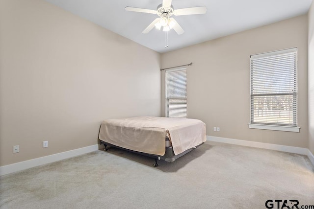 6023 Grace Ave, Tyler, TX 75707 - bedroom with multiple windows, light colored carpet, and ceiling fan