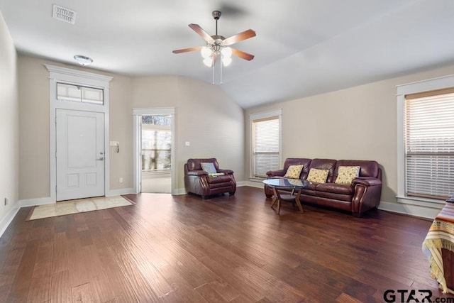 living room featuring dark hardwood / wood-style flooring, vaulted ceiling, and ceiling fan