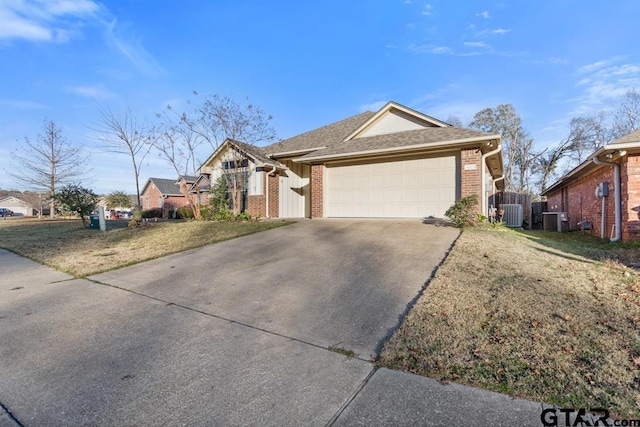 ranch-style house featuring central AC, a front lawn, and a garage