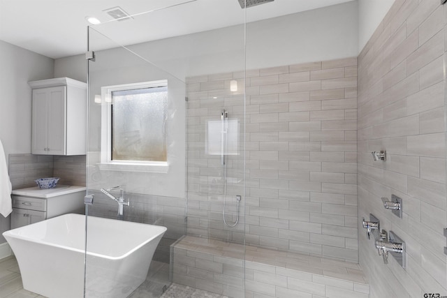 bathroom featuring separate shower and tub