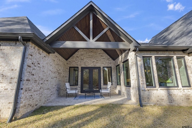 rear view of house featuring french doors, a yard, and a patio