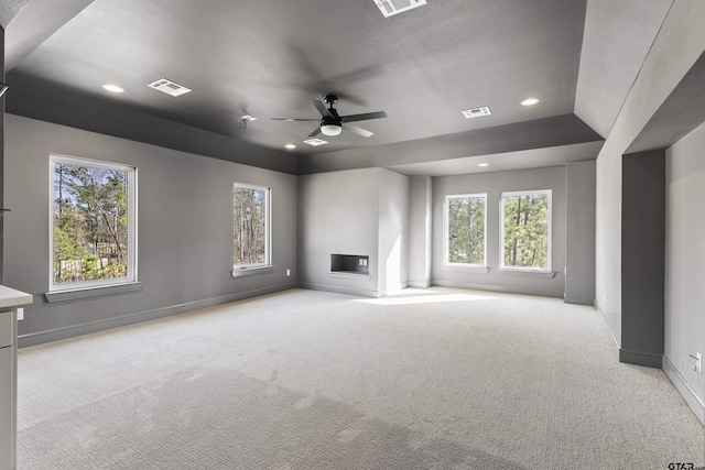 unfurnished living room with ceiling fan and light colored carpet